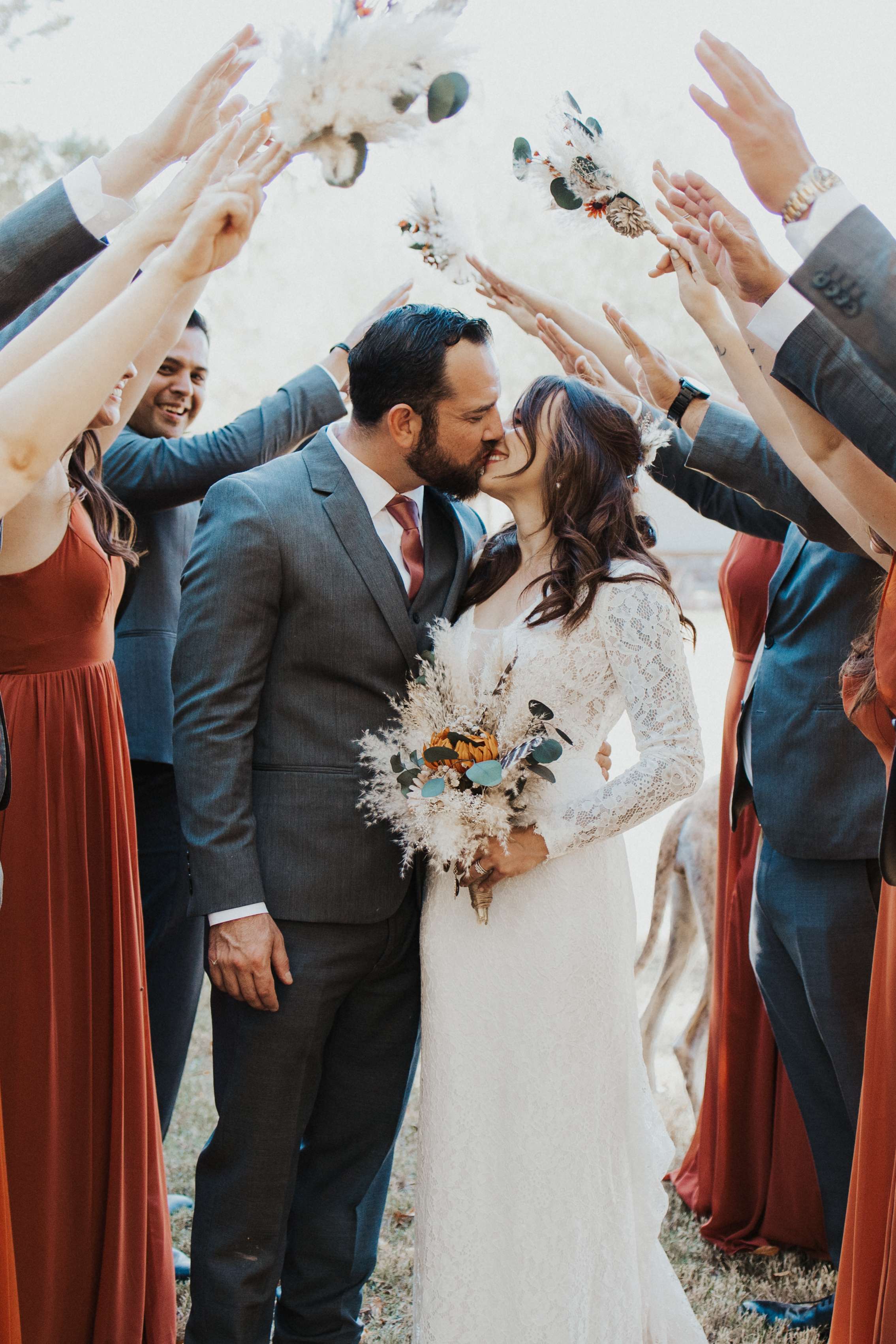 A bride and groom are surrounded by their wedding party