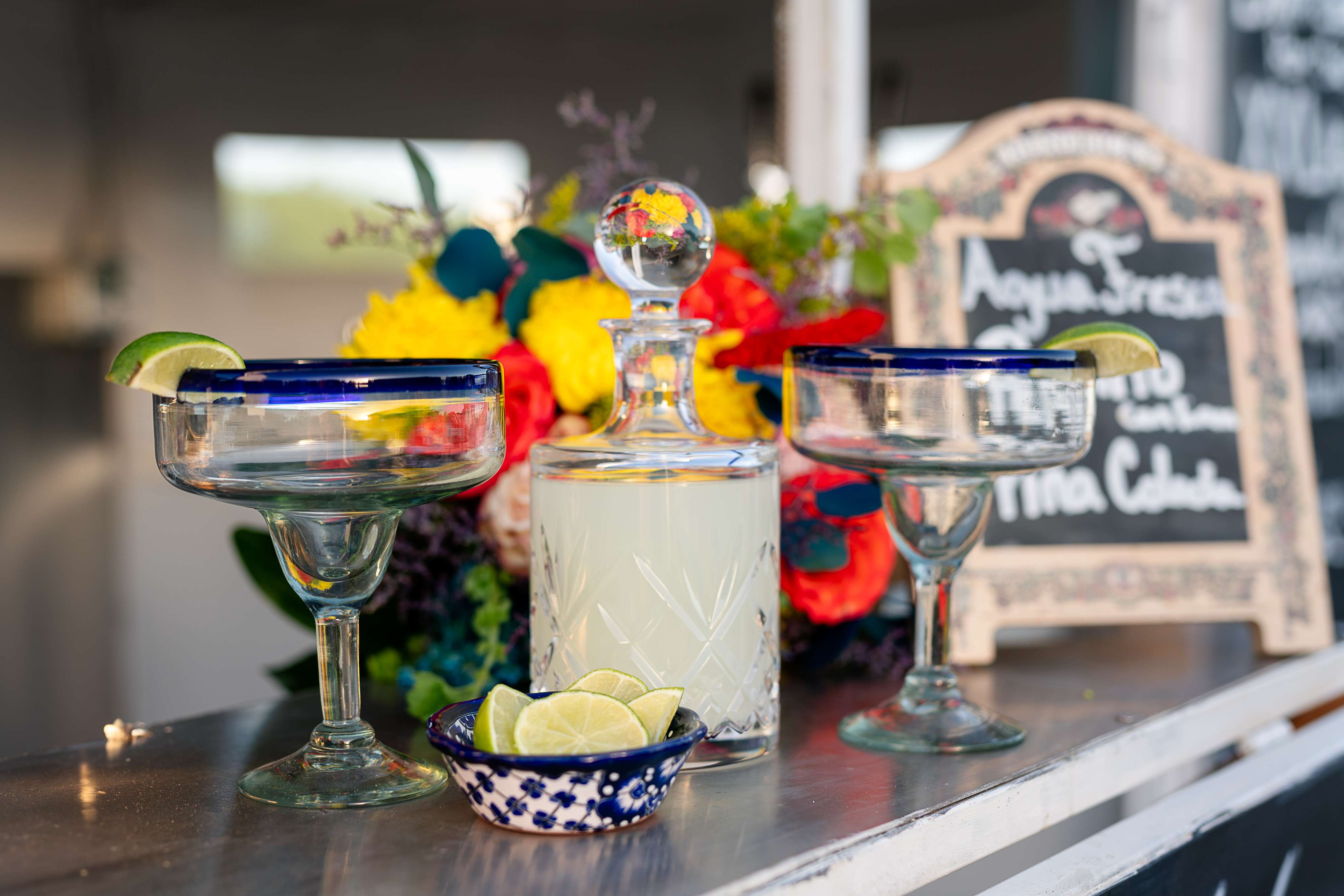 A table topped with glasses and a bottle of alcohol