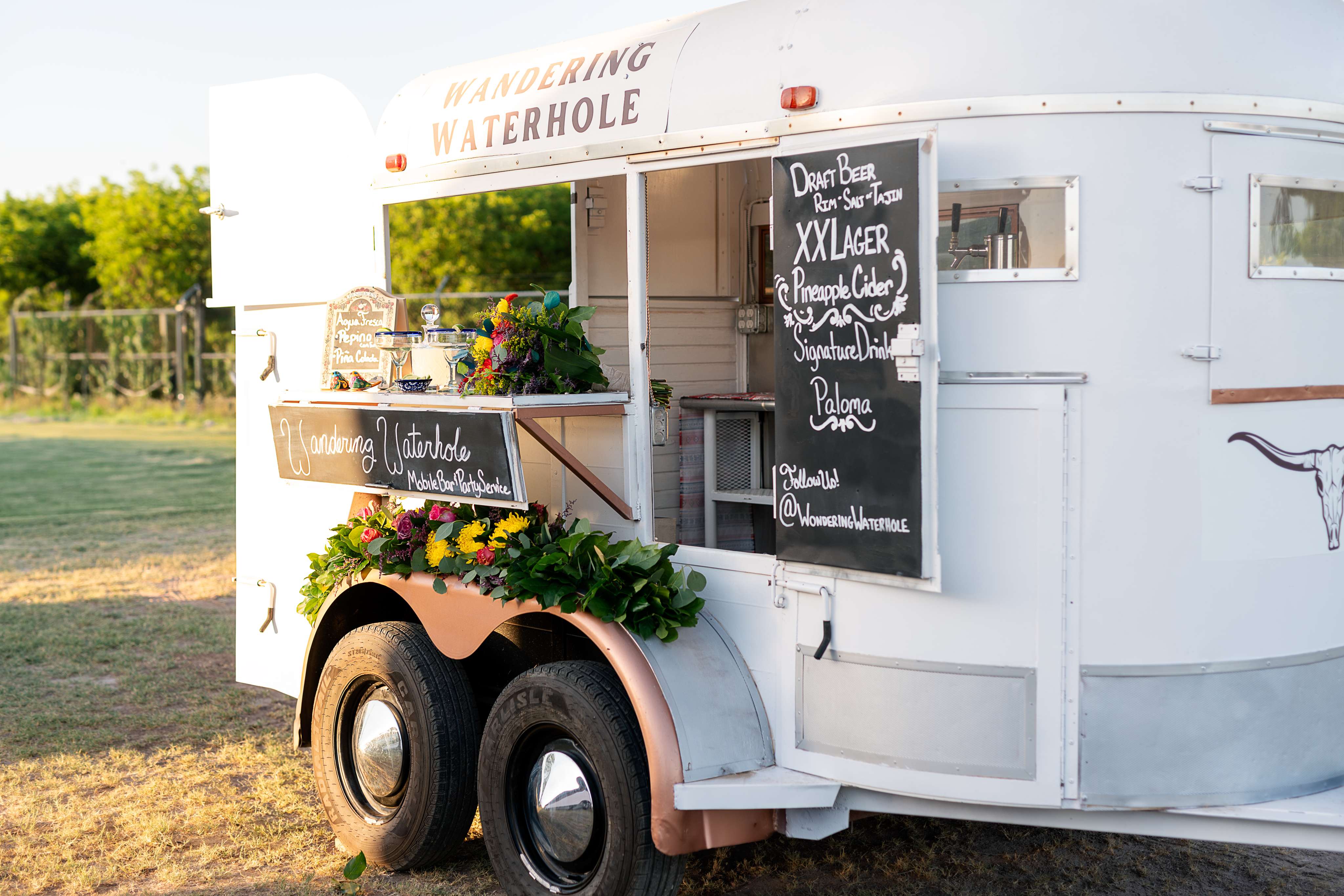 A food truck is parked in a field